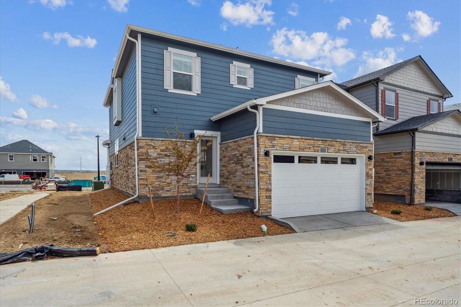 Front exterior of a new home in Horizon Uptown, Aurora, CO, highlighting curb appeal (Image 1). Front exterior of a new home in Horizon Uptown, Aurora, CO, highlighting curb appeal (Image 1).
