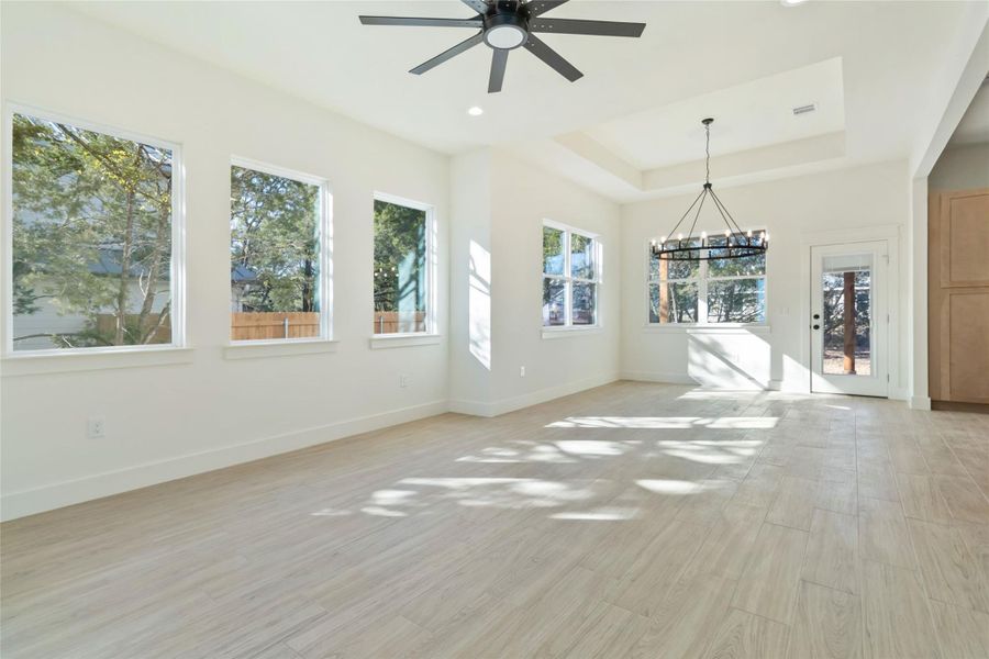 Living area without virtual staging and view of dining room with chandelier Living area without virtual staging and view of dining room with chandelier