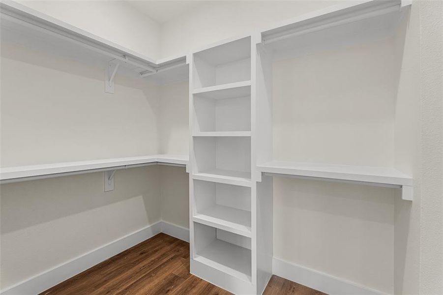 Walk in closet with dark wood-type flooring Walk in closet with dark wood-type flooring