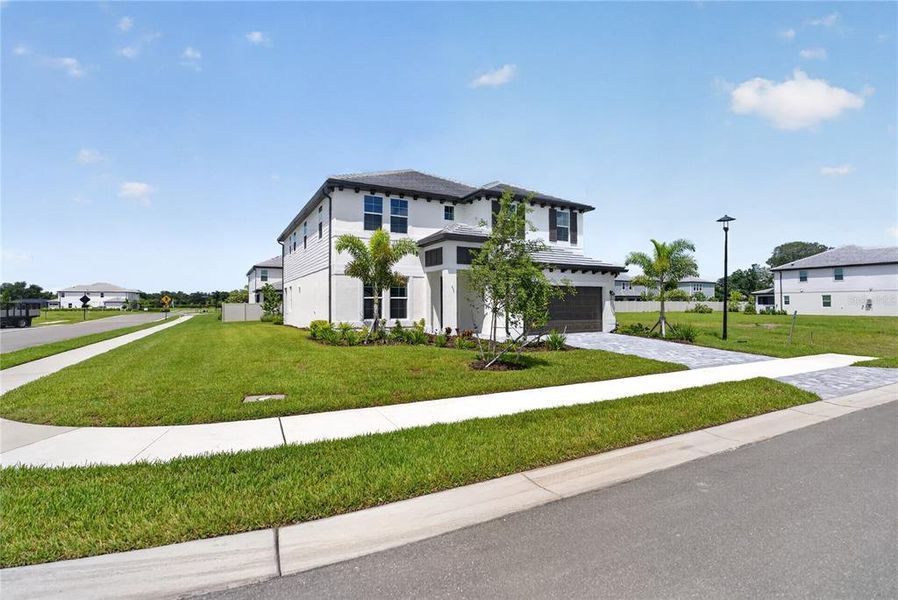 Front exterior of a new home in , Sarasota, FL, highlighting curb appeal (Image 27).