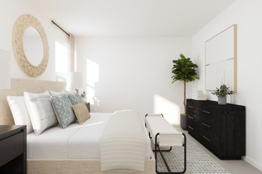 A room with a white couch and a table with a plant on it. A room with a white couch and a table with a plant on it.