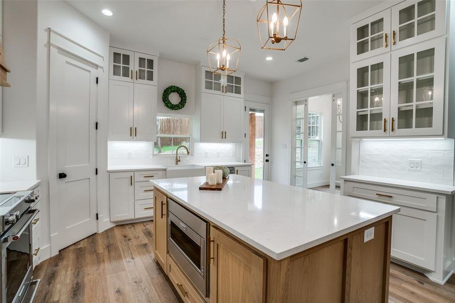 Kitchen with white cabinets, a center island, and appliances with stainless steel finishes