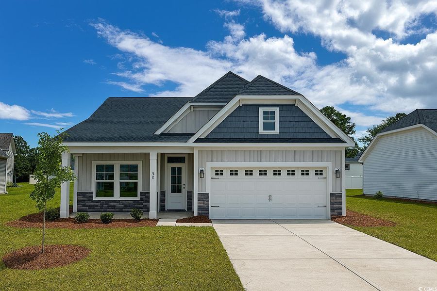 Craftsman inspired home with a front lawn, stone siding, and a shingled roof