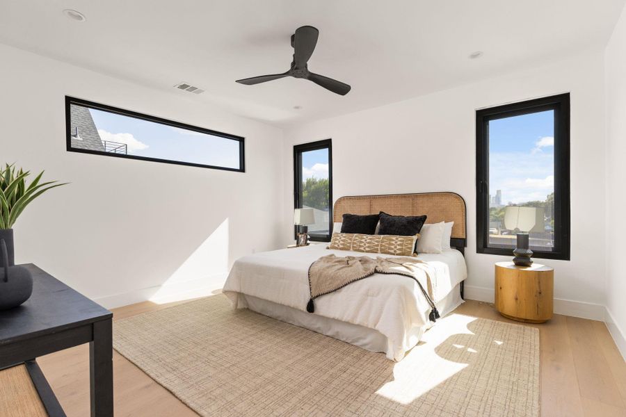 Sun-filled bedroom offers ample natural light and clean, minimalist design.