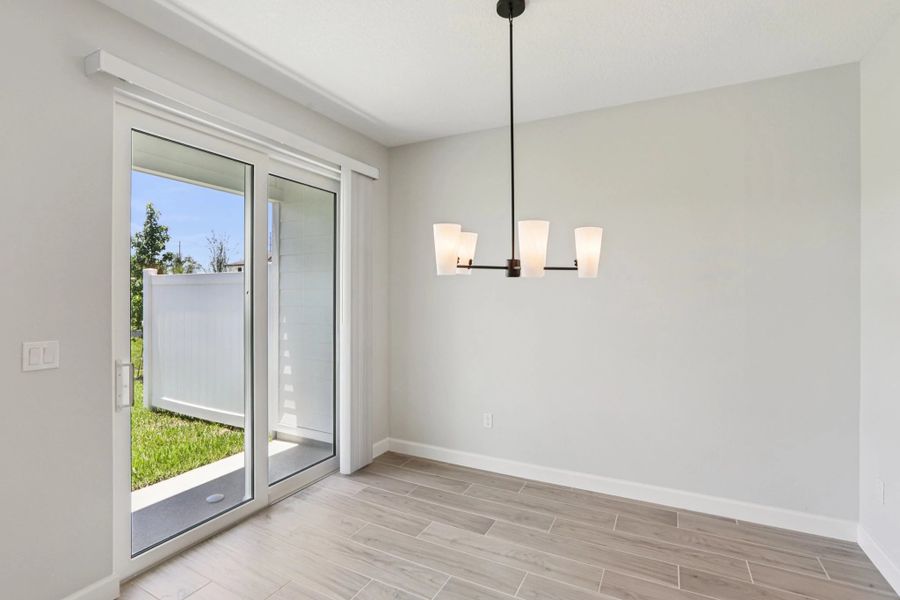 Dining room looks out on to the covered back lanai -  Representative images and renderings are for illustrative purposes