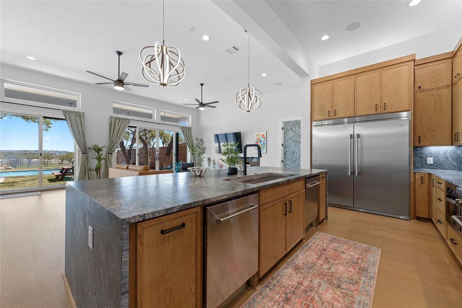 This stunning kitchen offers both style and functionality—featuring crisp white cabinetry, designer lighting, and a spacious island with seating for six. Perfect for casual meals, entertaining, or gathering with friends and family in your Canyon Lake getaway.