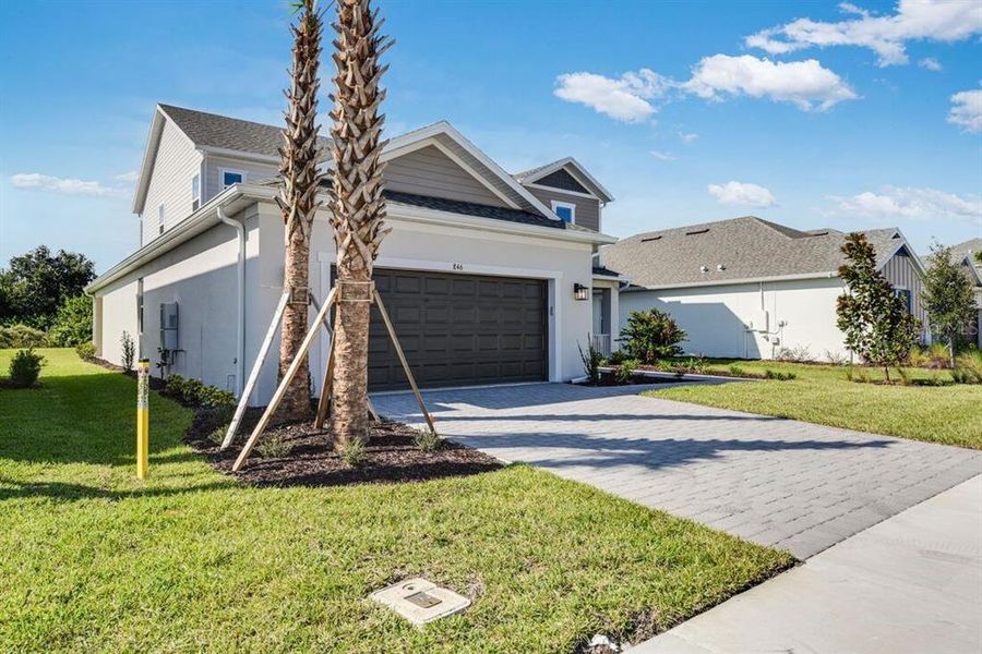 Front exterior of a new home in Ardisia Park, New Smyrna Beach, FL, highlighting curb appeal (Image 1).