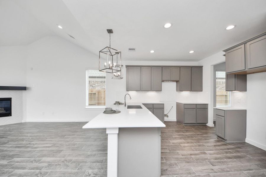 The extended counter area adds both practicality and style, making meal preparation a breeze. Every detail is thoughtfully designed to enhance the kitchen's functionality and aesthetic appeal. Sample photo of completed home with similar floor plan. Actual colors and selections may vary.