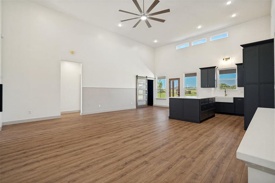 Open-concept living area with vaulted ceilings and wood-finish flooring