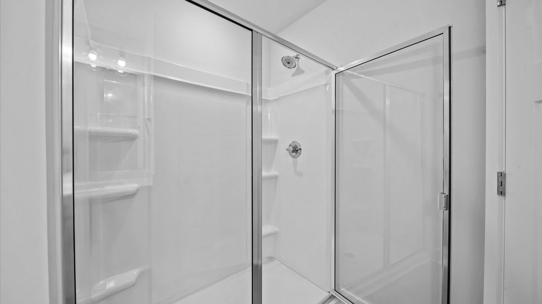 Glass-enclosed walk-in shower for superior everyday comfort at Saluda Crossing by DRB Homes in Piedmont, SC