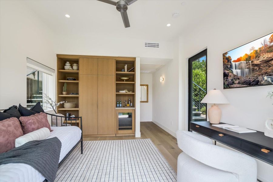 Room featuring wood-finish flooring, a vaulted ceiling, recessed lighting, and a modern ceiling fan