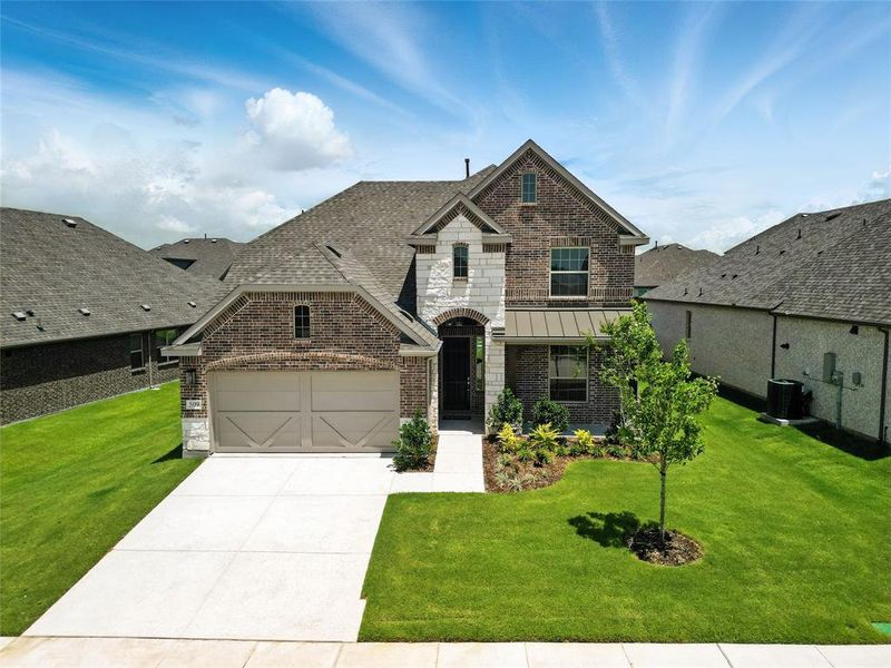 French provincial home with brick siding, driveway, and a front yard French provincial home with brick siding, driveway, and a front yard