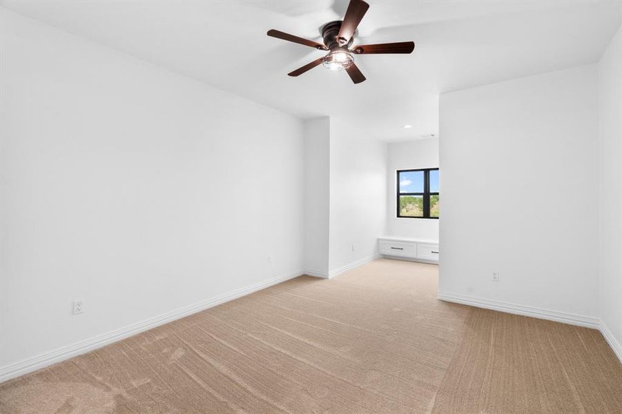 Spare room with light colored carpet and a ceiling fan Spare room with light colored carpet and a ceiling fan
