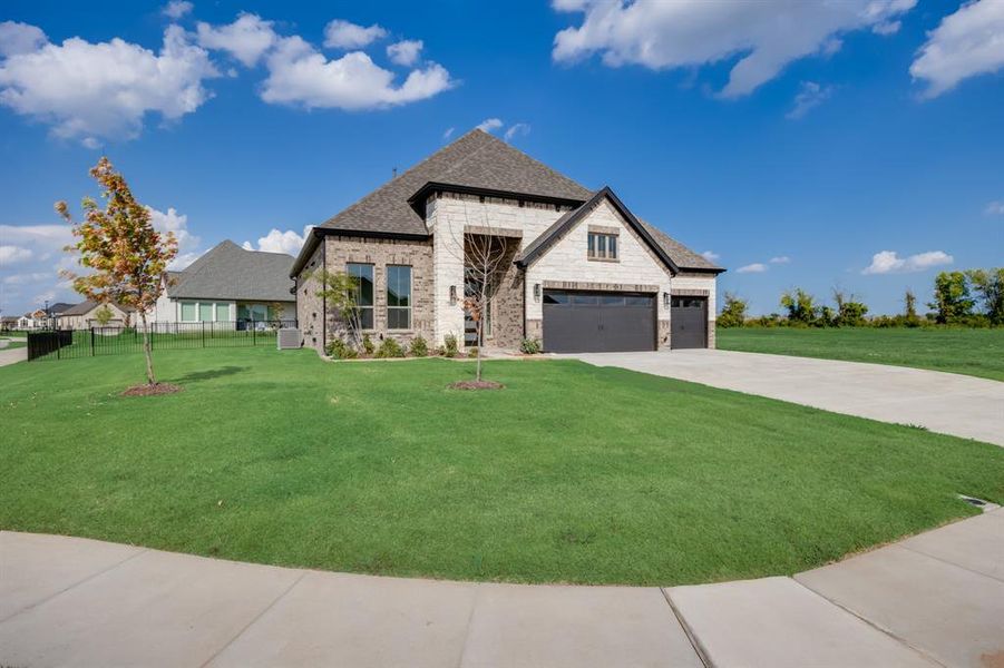 Front exterior of a new home in Heath Golf and Yacht, Heath, TX, highlighting curb appeal (Image 23). Front exterior of a new home in Heath Golf and Yacht, Heath, TX, highlighting curb appeal (Image 23).