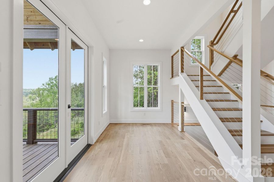 Dining area leading to covered, vaulted back porch