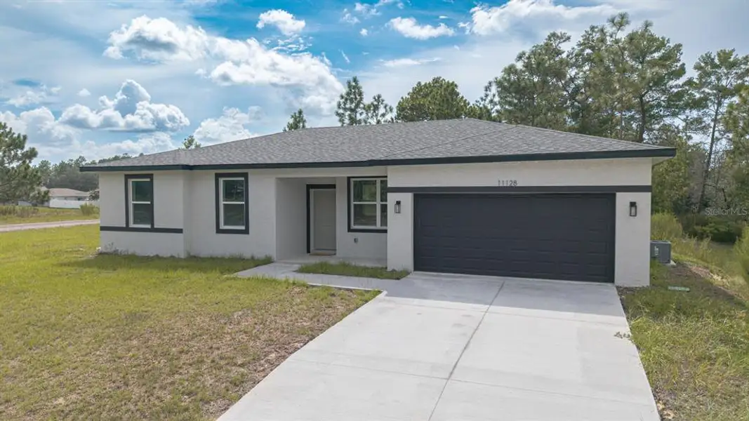 Front exterior of a new home in , Citrus Springs, FL, highlighting curb appeal (Image 24).