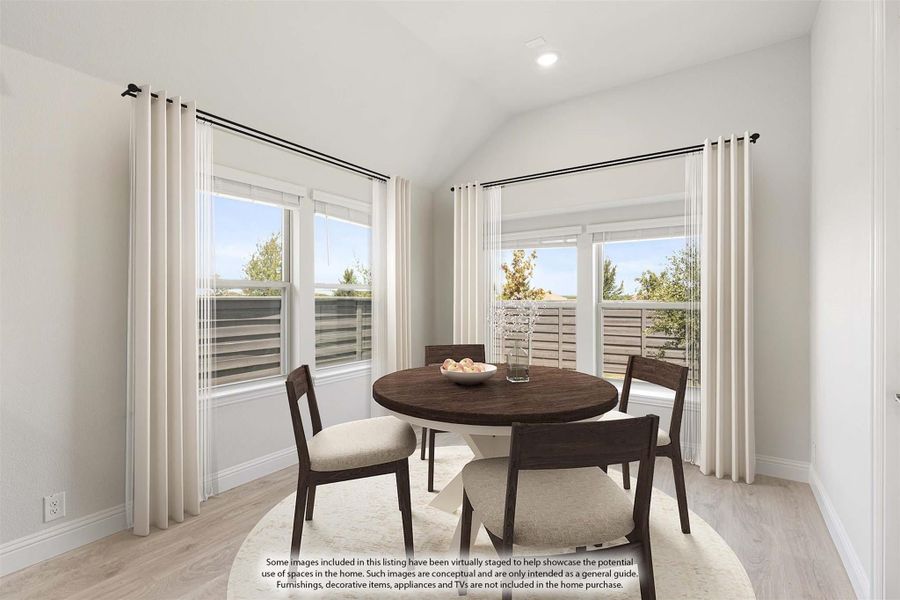 Dining area with round dark wood table, four chairs, vaulted ceiling, and large windows with white curtains