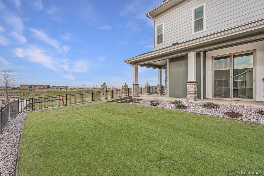 Fenced in yard. Turf virtually stage due to weather. Turf will be installed according to landscaping plans when weather permits.