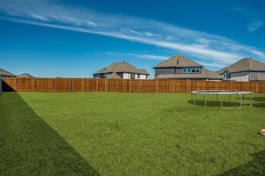 View of yard featuring a trampoline