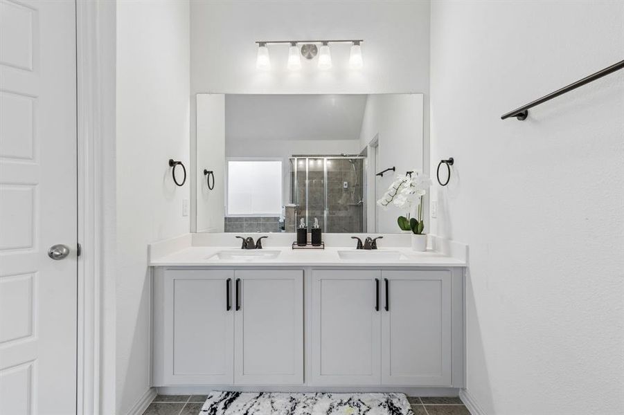 Double vanity with white cabinetry and integrated sinks