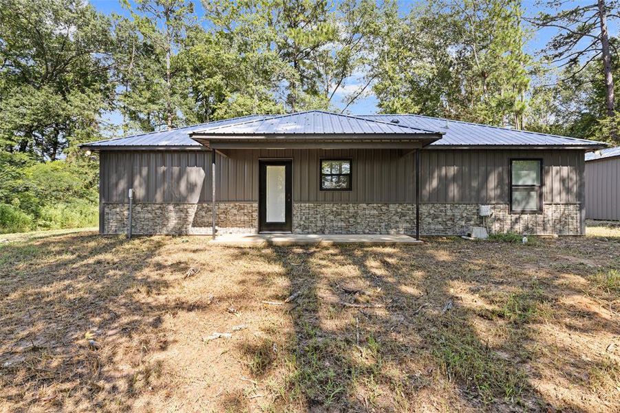 View of front of house featuring stone metal siding View of front of house featuring stone metal siding