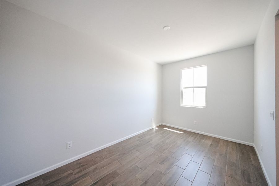 A room with a tile floor and windows.