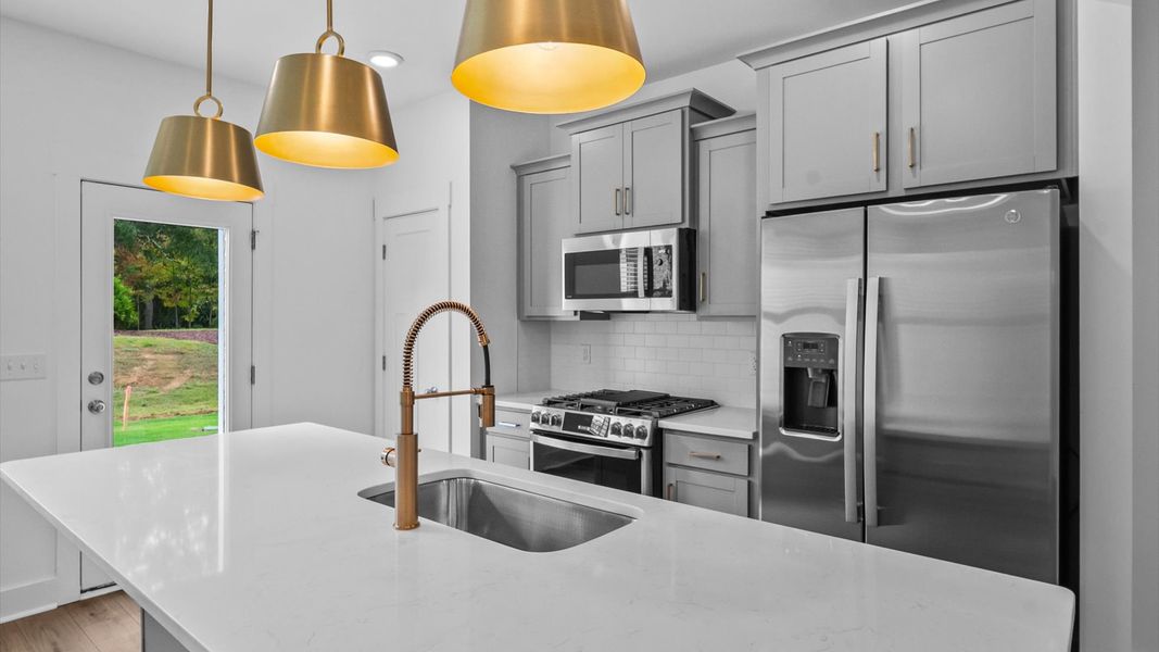 Elegant and compact island anchors this tasteful kitchen with high standards and timeless appeal at Ransdell Pointe