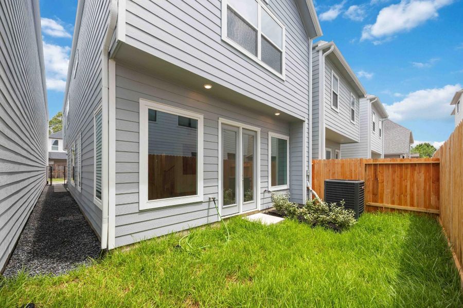 Enjoy a little green space without the upkeep. This private, low-maintenance backyard is ideal for letting pets out, catching a bit of sun, or starting your herb garden.