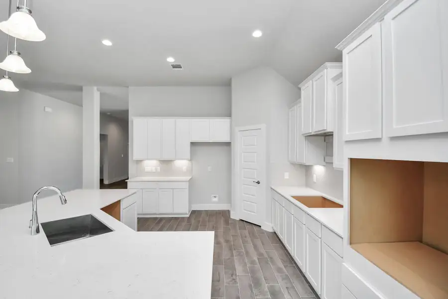 The open concept effortlessly connects the kitchen to the expansive family room, forming a perfect hub for gatherings. This seamless flow creates an inviting space where cooking and socializing come together harmoniously. Sample photo of completed home with similar floor plan. Actual colors and selections may vary. The open concept effortlessly connects the kitchen to the expansive family room, forming a perfect hub for gatherings. This seamless flow creates an inviting space where cooking and socializing come together harmoniously. Sample photo of completed home with similar floor plan. Actual colors and selections may vary.