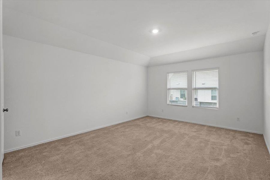 A spacious room offers comfortable carpeting and natural light through twin windows. A spacious room offers comfortable carpeting and natural light through twin windows.