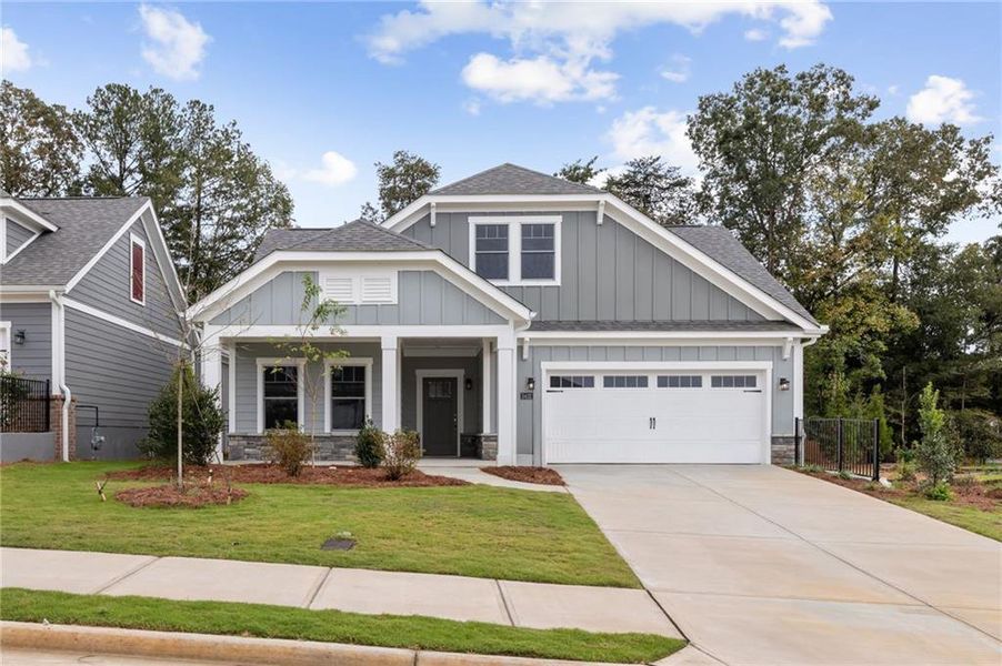 Front exterior of a new home in The Courtyards at Bailey Farm, Dacula, GA, highlighting curb appeal (Image 1).