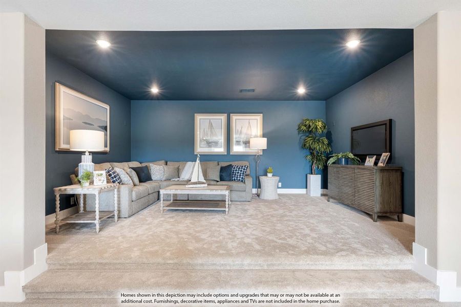 Sunken living room with blue walls, gray sectional sofa, carpet flooring, and recessed lighting