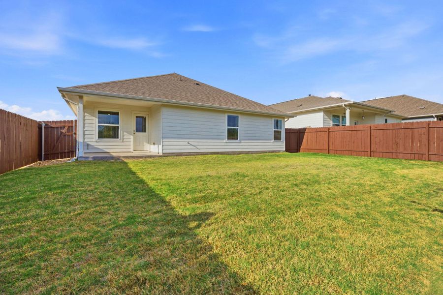 Rear view of house featuring a fenced backyard, roof with shingles, and a patio Rear view of house featuring a fenced backyard, roof with shingles, and a patio