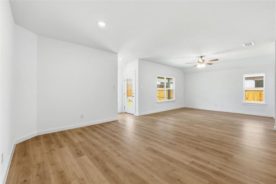 Spare room with light wood finished floors, a ceiling fan, and recessed lighting