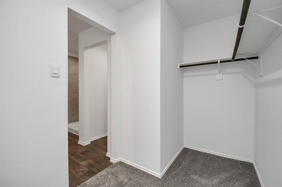 Walk-in closet in the primary bedroom.