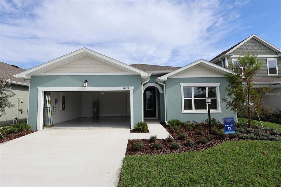 Front exterior of a new home in The Peninsula at Rhodine Lake, Riverview, FL, highlighting curb appeal (Image 23).