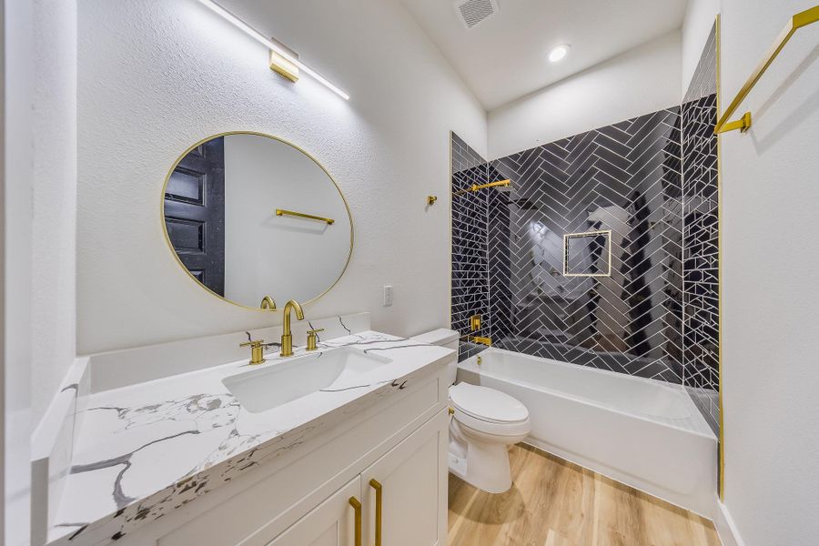 Second bathroom features stylish black and gold touches, adding elegance and a modern, luxurious feel to the space. Second bathroom features stylish black and gold touches, adding elegance and a modern, luxurious feel to the space.