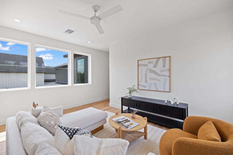 Living area with wood finished floors, recessed lighting, and a ceiling fan Living area with wood finished floors, recessed lighting, and a ceiling fan