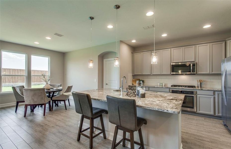 *Model Representation - Spacious kitchen with eat-in bartop island