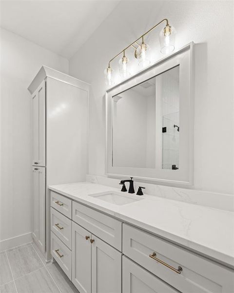 Bathroom with a tile shower and vanity