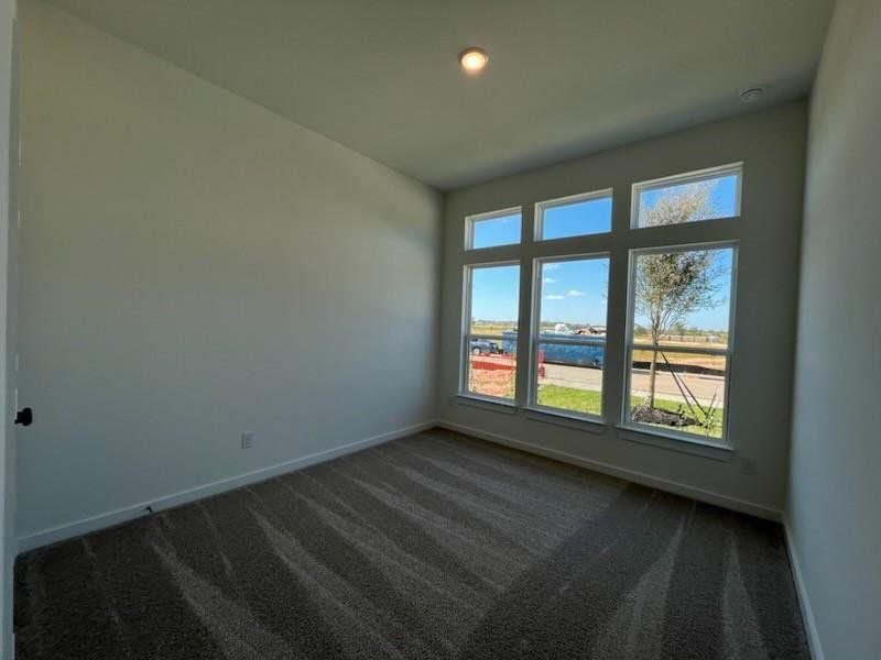 A secondary bedroom is located at the front of the home, complete with a full bath.