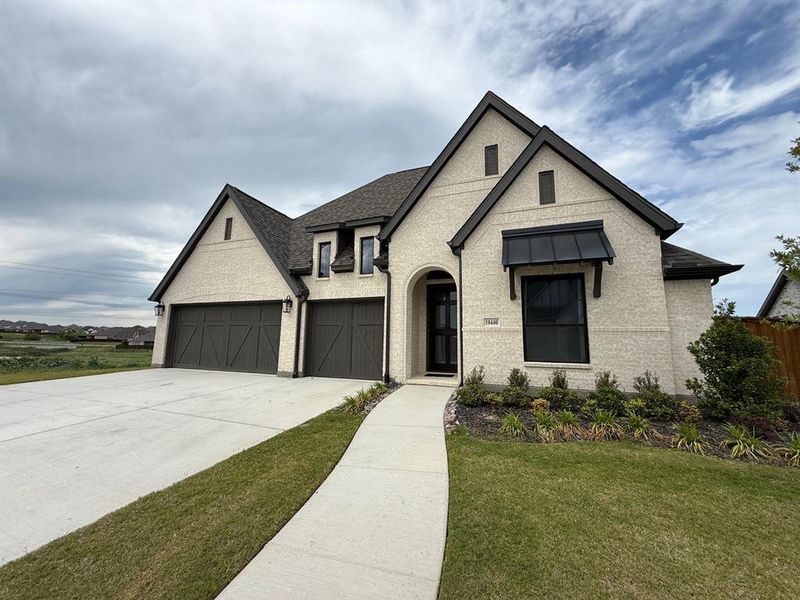 Front exterior of a new home in Ventana, Fort Worth, TX, highlighting curb appeal (Image 2). Front exterior of a new home in Ventana, Fort Worth, TX, highlighting curb appeal (Image 2).