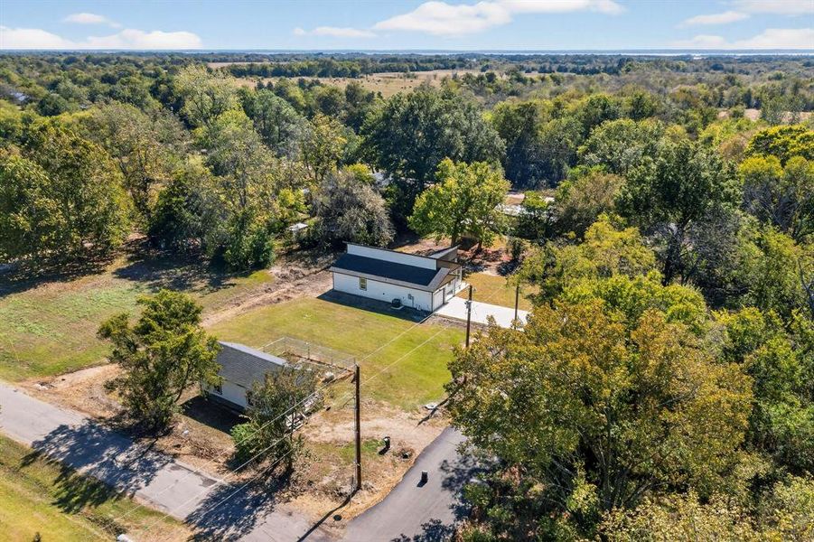View from above of property with a heavily wooded area View from above of property with a heavily wooded area