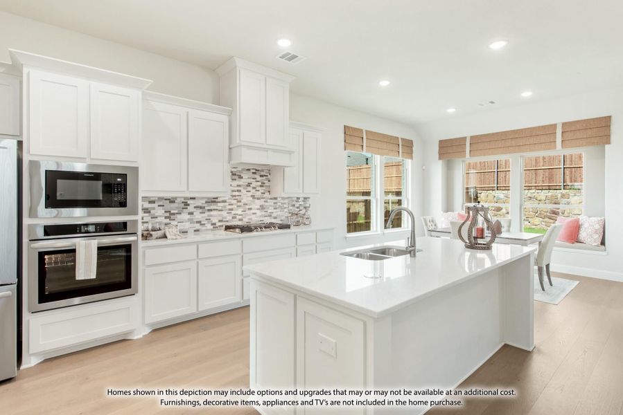 Kitchen with white cabinets, center island with sink, stainless steel appliances, and tile backsplash Kitchen with white cabinets, center island with sink, stainless steel appliances, and tile backsplash