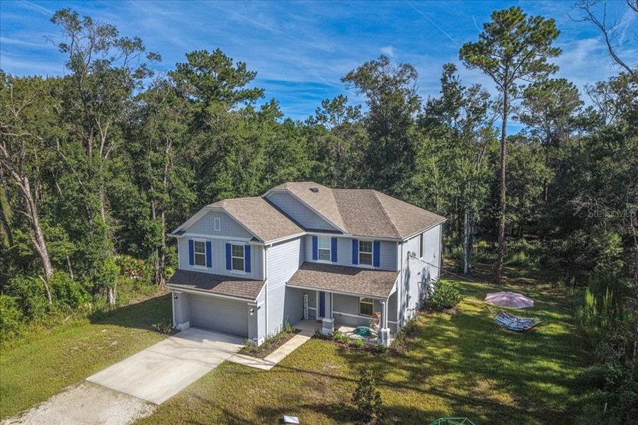Front exterior of a new home in Flagler Estates, Hastings, FL, highlighting curb appeal (Image 32).