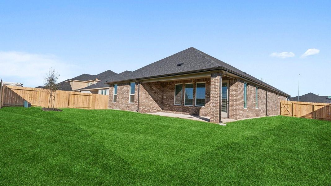 Large fenced-in backyard with a covered patio, perfect for outdoor entertaining.
