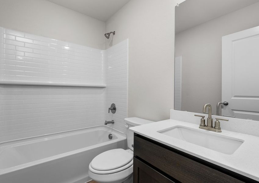 The secondary bathroom has a vanity space and a shower-tub combo.