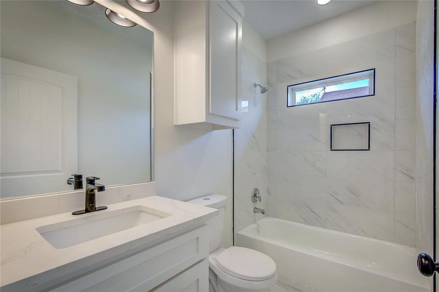 Full bathroom featuring shower / bath combination and vanity Full bathroom featuring shower / bath combination and vanity