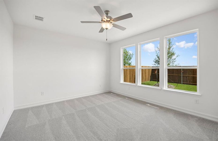 Primary bedroom with large windows