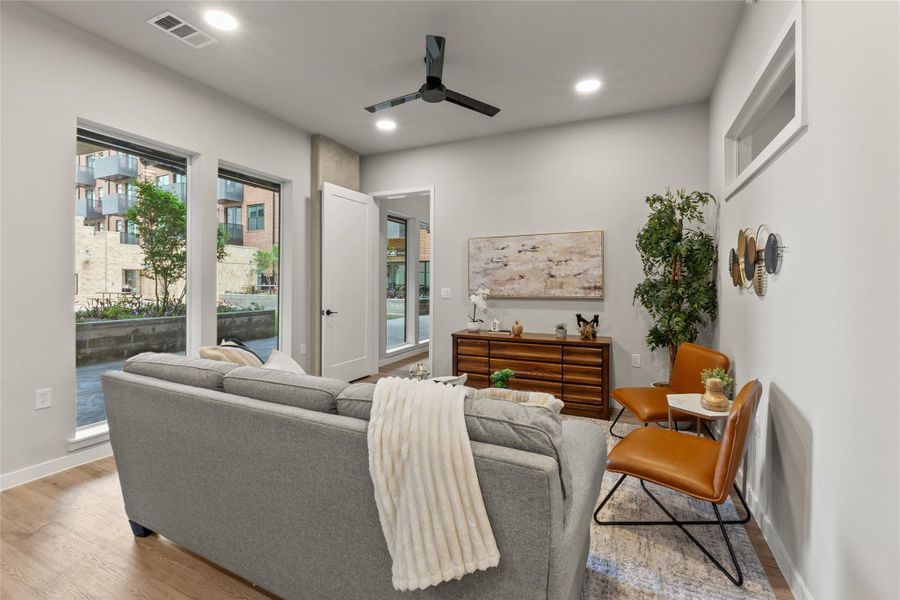 Living room featuring a ceiling fan, wood finished floors, and recessed lighting